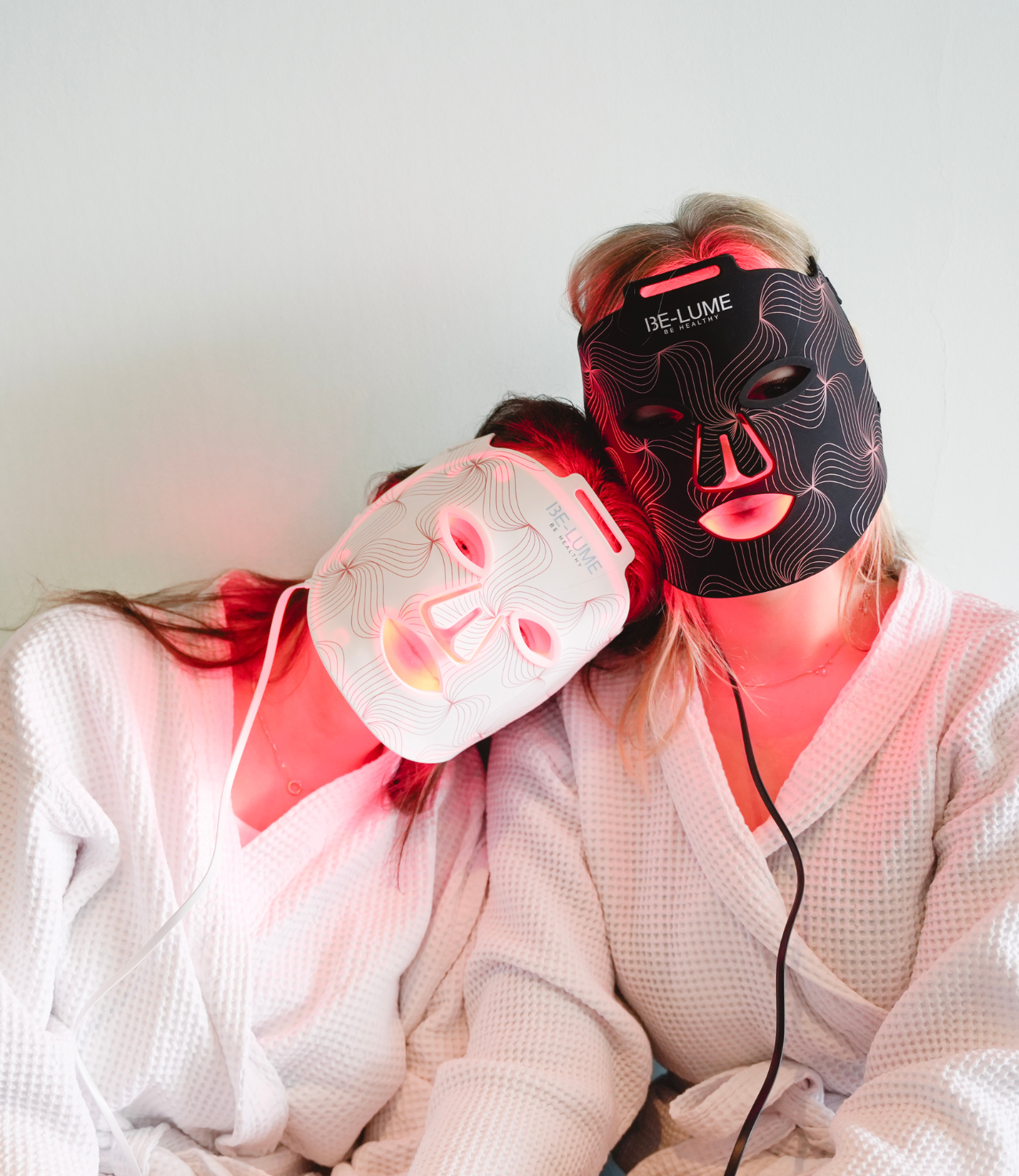 Woman using light therapy mask for skincare